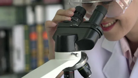 Scientist woman is looking microscope. Stock-Footage 173594932