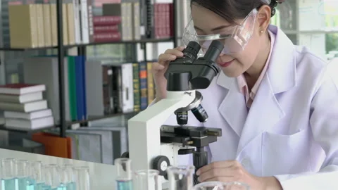 Scientist woman is looking microscope. Stock-Footage 173595186