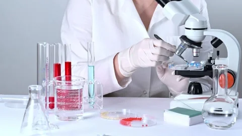 Scientist working in a biotechnological laboratory with microscope Stock Footage 273578390