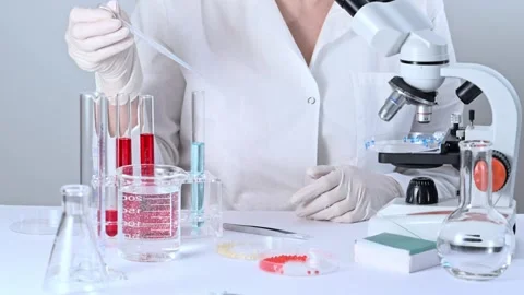 Scientist working in a biotechnological laboratory with microscope. Video stock 276156311