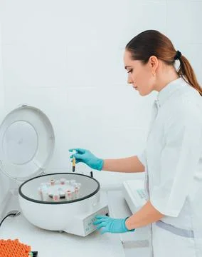 Scientist working with blood samples in vials on a centrifuge machine. Bloo.. Fotos Stock