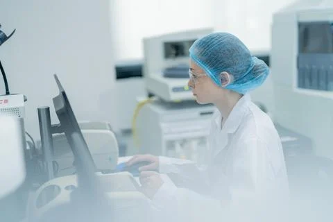 Scientist working diligently in a laboratory setting during daylight hours,.. Stock Photos