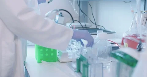 Scientist working in a hospital medical laboratory conducting experiments Stock Footage
