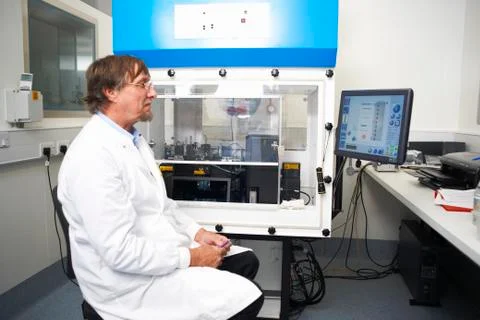 Scientist working in lab with computer and scientific machine 스톡 사진