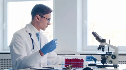 Scientist working in lab. Doctor making microbiology research. Laboratory tools Stock Footage 129684305