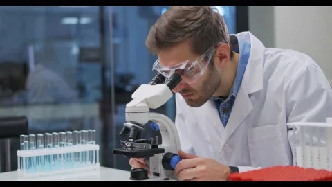 Scientist working in lab. Doctor making medical research using microscope Stock-Footage 144502587