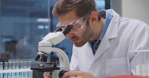Scientist working in lab. Doctor making medical research using microscope Stock-Footage 144639807