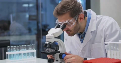 Scientist working in lab. Doctor making medical research using microscope Video stock 144639825