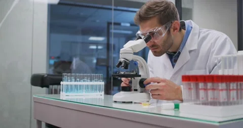 Scientist working in lab. Doctor making medical research using microscope Stock-Footage 144807926