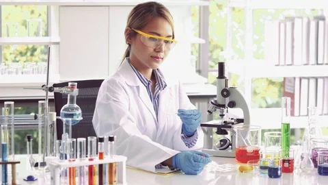 Scientist working in lab with mircroscope Stock Footage 105606963