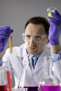 Scientist working at lab with test tubes flasks, performing science experiments Stock Photos