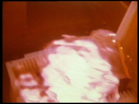 Scientist working in laboratory, checking microchips under microscope, 1985 Stock Footage 136673919