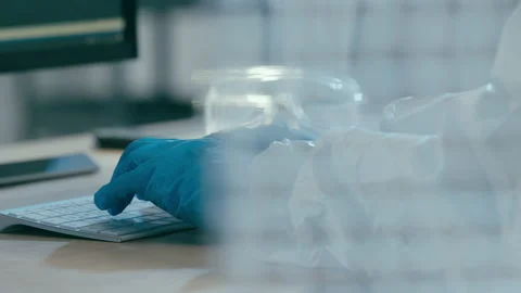 Scientist working in laboratory at computer keyboard Stock Footage 149245885