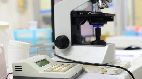 Scientist working in laboratory with microscope Stock Footage 75784928