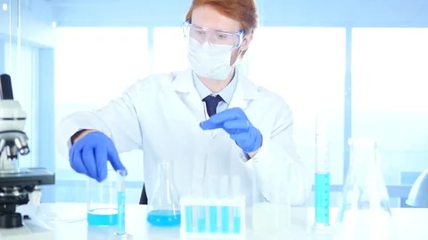 Scientist Working in Laboratory, Pouring Chemical Solution in Test Tube Stock Footage 80944829