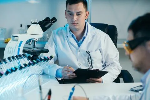 Scientist working with microscope in lab. Laboratory research concept. Foto stock