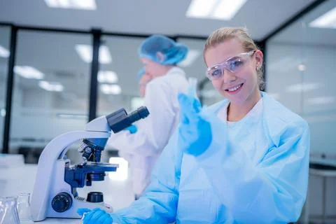 Scientist working with microscope in laboratory during research in modern f.. Stock Photos