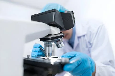 Scientist Working with Microscope in Laboratory Stock Photos
