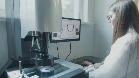 Scientist working with microscope in manufacturing laboratory Stock-Footage 152448573