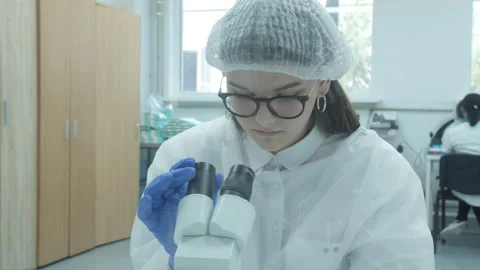 Scientist working with microscope in manufacturing laboratory Video stock 152449103
