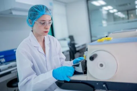 Scientist working in a modern lab with advanced equipment during daylight hou Stock Photos