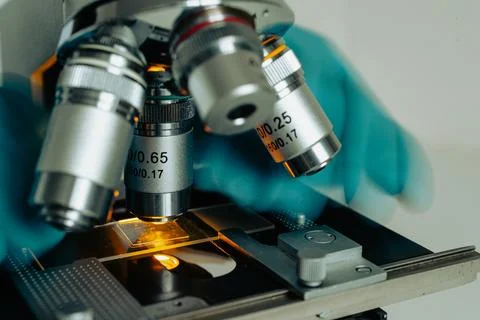 Scientist working with optical microscope Stock Photos