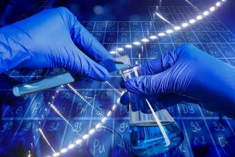 Scientist working with sample, periodic table of chemical elements and test.. Stock Photos