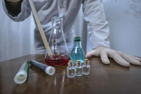 Scientist working with test tubes and colorful liquids in laboratory Foto stock