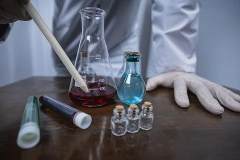 Scientist working with test tubes and colorful liquids in laboratory Stock Photos