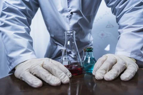 Scientist working with test tubes and colorful liquids in laboratory Foto stock