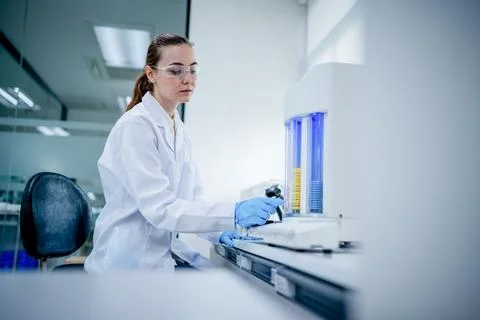 Scientist works in a lab on an experiment with lab equipment and samples du.. Stock Photos