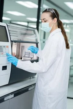 Scientist works with a laboratory machine for testing samples in a modern l.. Stockfoto's