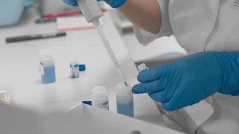 Scientist works with samples of human blood in sterile medical laboratory Stock Footage 147594154