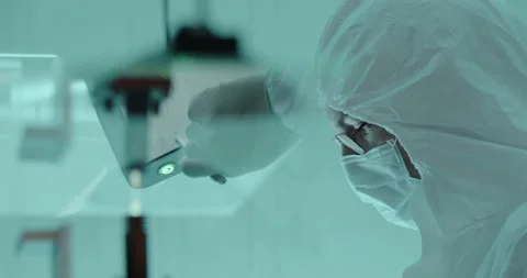 Scientist works with tablet in cleanroom Stock Footage 232901440