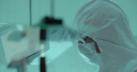 Scientist works with tablet in cleanroom Stock Footage 232902142