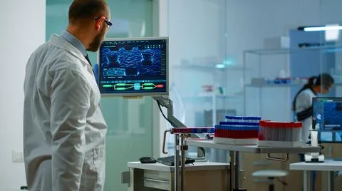 Scientist worried about virus evolution analysing DNA scan image Stock Photos