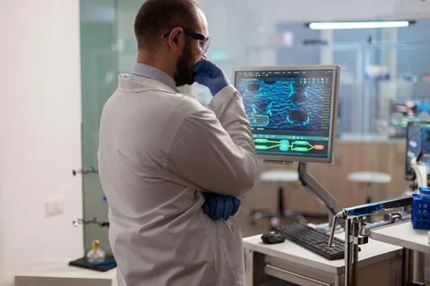 Scientist worried about virus evolution analysing DNA scan image Stock Photos