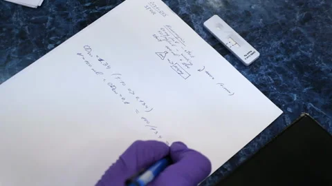 Scientist writes down the technique on a paper sheet Stock Footage 171526571