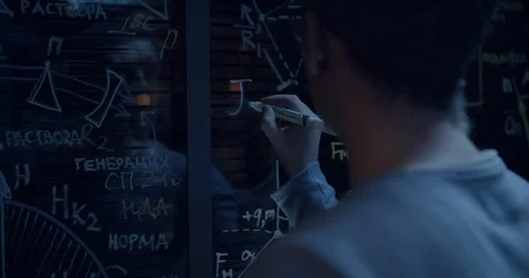Scientist writes the formula on the glass Stock Footage 108417484