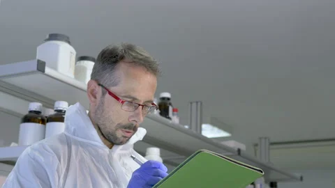 Scientist writing data from his research in the laboratory. Selective focus. Stock-Footage 145706418