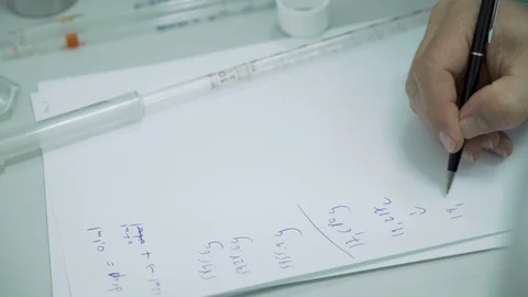 Scientist writing down measurements from research in notebook at Hemp CBD Stock Footage 116610258