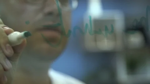 Scientist writing formulas on glass Stock Footage 113188546