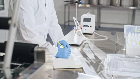 Scientist writing observations during experiment Stock Footage 84683294