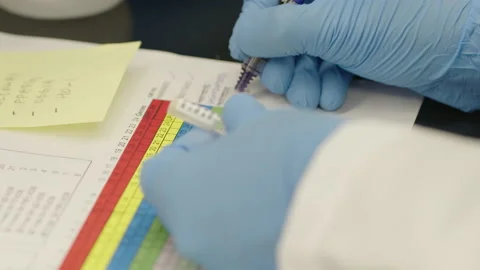 Scientist writing results Stock Footage 148860963