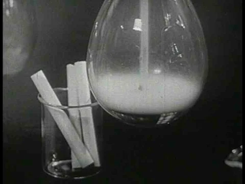 Scientists analyze the content of cigarettes and analyze smoking in this 1954 Stock Footage 74717571