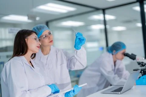 Scientists analyze samples in a modern laboratory during a research project.. Stock Photos