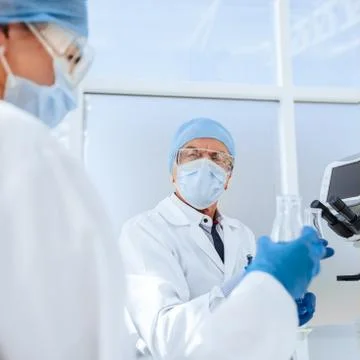 Scientists and doctors work in a modern laboratory. Stock Photos