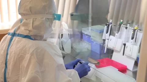 Scientists are developing a vaccine. in a protective, sterile suit. Video stock 141883578