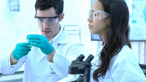 Scientists are experimenting with chemicals compound and liquid the test tube. Stock Footage 109130849