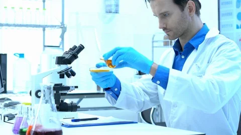 Scientists are experimenting with chemicals compound and absorb liquid Stock Footage 111667186